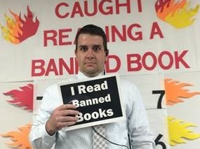 Assitant Principal Kendall Still was caught reading a banned book. Mrs. Lambert, the librarian take his mug shot in the library during Banned Books Week. 