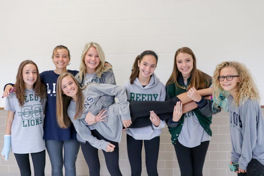 Varsity+Cross+Country+holds+freshman+Colleen+Steggman+after+the+State+Send+Off+in+the+hallways+at+Reedy.+