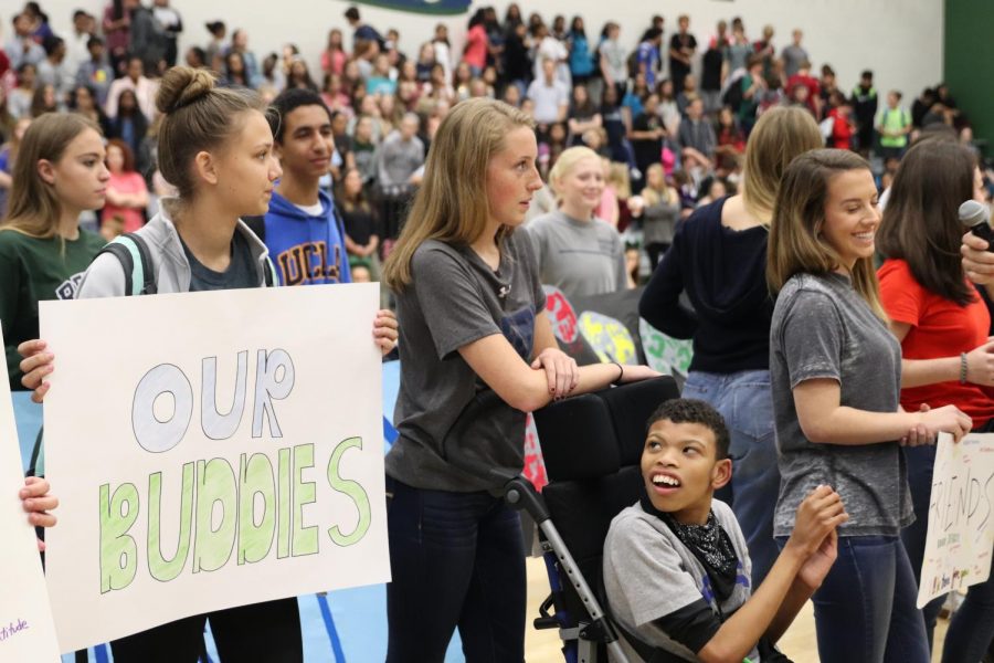 Senior+Victoria+Tamney+and+junior+Grace+Jensen+with+freshman+Dominic+Frezza+tell+the+crowd+what+Best+Buddies+is+thankful+for+at+the+Playoff+pep+rally%2C+Nov.+17.+