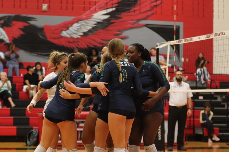 The varsity volleyball team prepares to play Liberty High School to start the 2022-23 season.  Photo By: Gigi Trigus; Editor-in-Chief of the Roar Yearbook