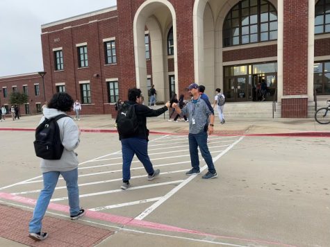Gilmore greets each student with a fist bump as they cross the parking lot to begin their day at Reedy on Nov. 3. Photo By: Elie Park