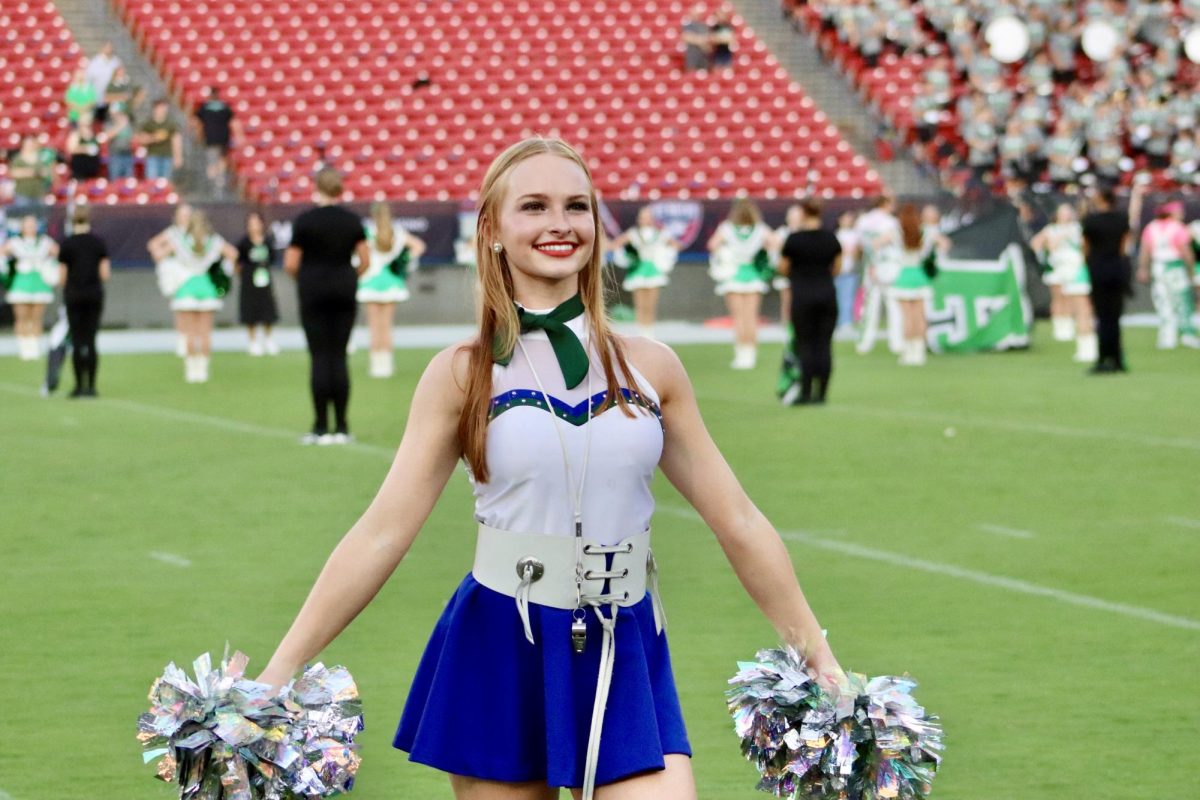Lindsay Brill on the field preparing for the football team to run on to the field. This is Brills fourth year as a Reedy Sapphire. 